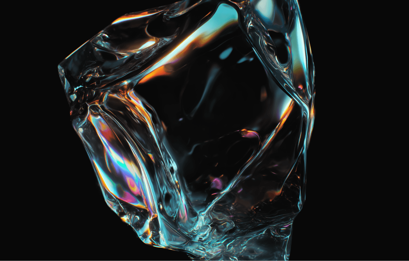 Faceted clear glass block on black, its edges splitting the light into orange, cyan and magenta